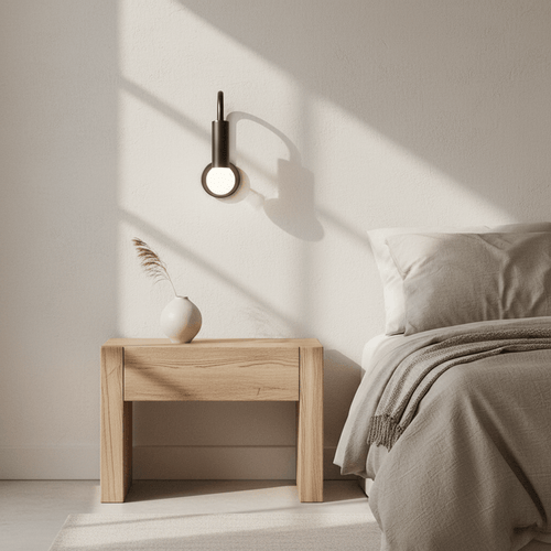 Modern wall light fixture with a single bulb on a dark background