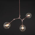 Modern chandelier with three glass bulbs on a dark background