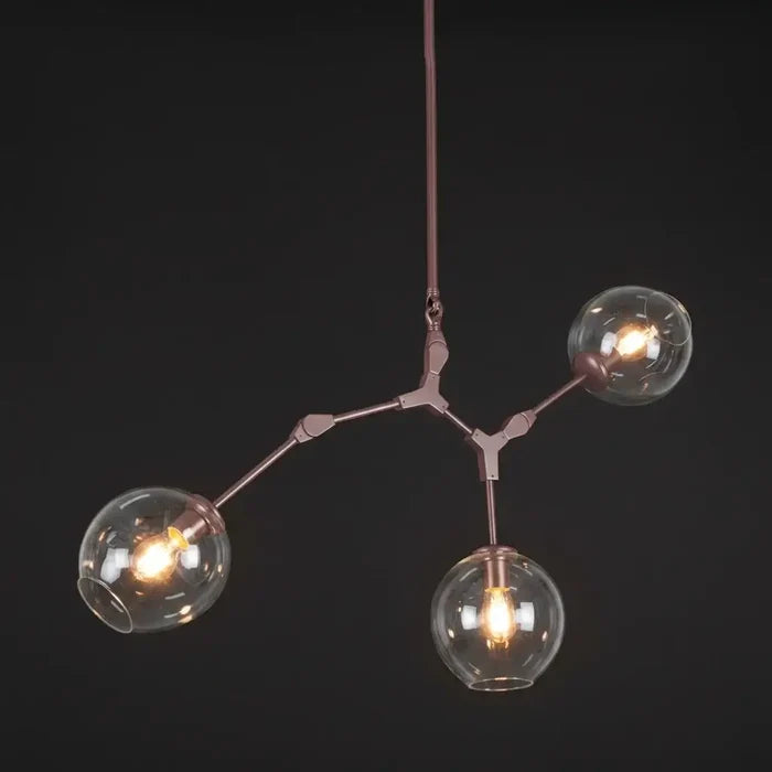 Modern chandelier with three glass bulbs on a dark background