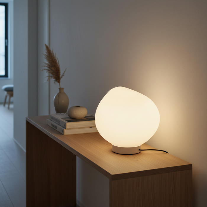 Asymmetrical white glass table lamp on console table