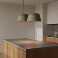 Green drum shaped pendant lights over contemporary kitchen island