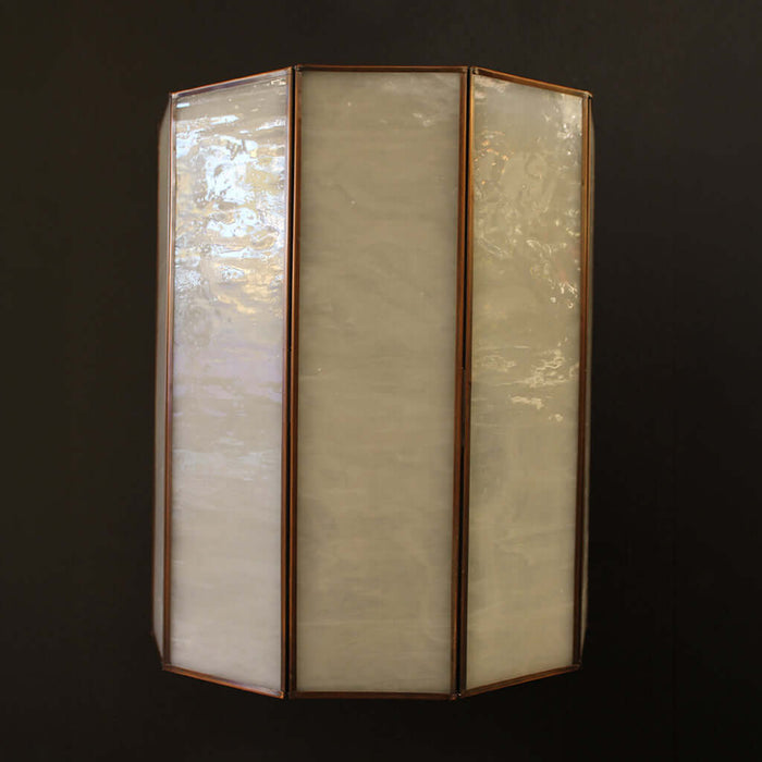 Tri-fold wall light fixture with glass panels on a dark background