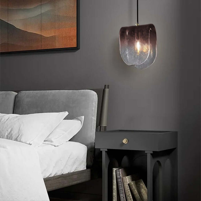 Modern bedroom with a bed, nightstand, and pendant light.