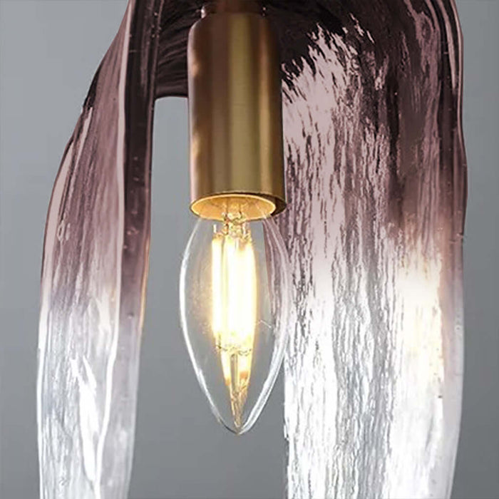 Light bulb inside a decorative lamp with a textured glass shade on a gray background