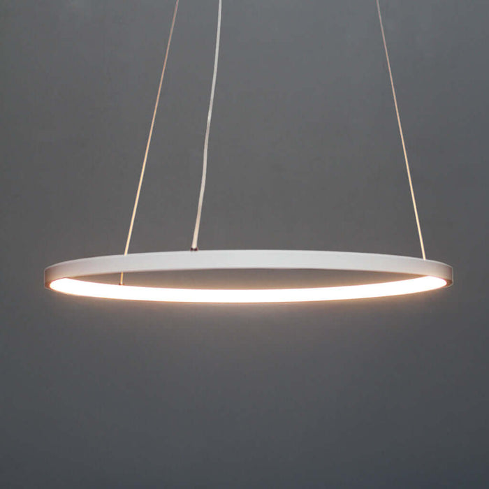 Modern pendant light with a white circular shade on a dark gray background