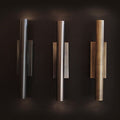 Three wall lights in varying finishes