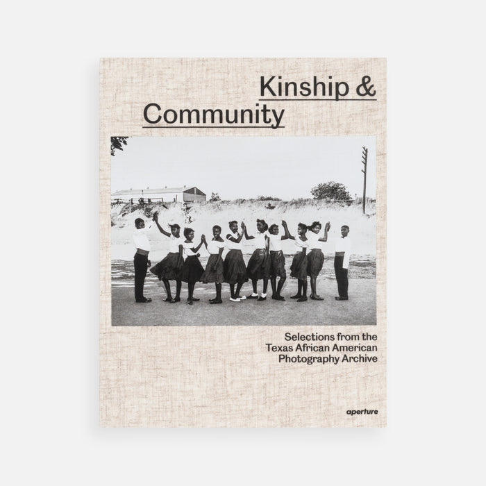 Book cover titled 'Kinship & Community' with a black and white photo of people holding hands on a beige background.