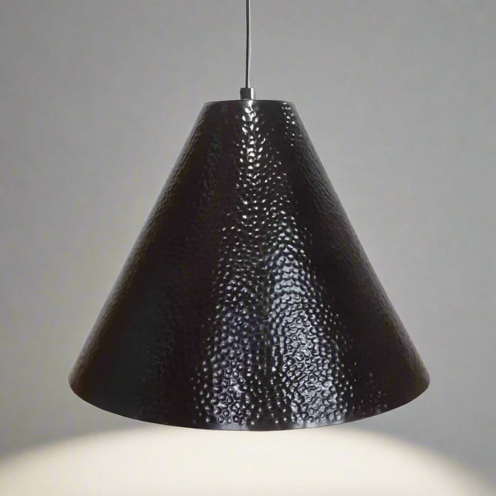 Black textured pendant light against a gray background