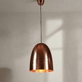 A tall domed pendant light with a hammered metal texture, constructed from a brass base, with a copper finish.