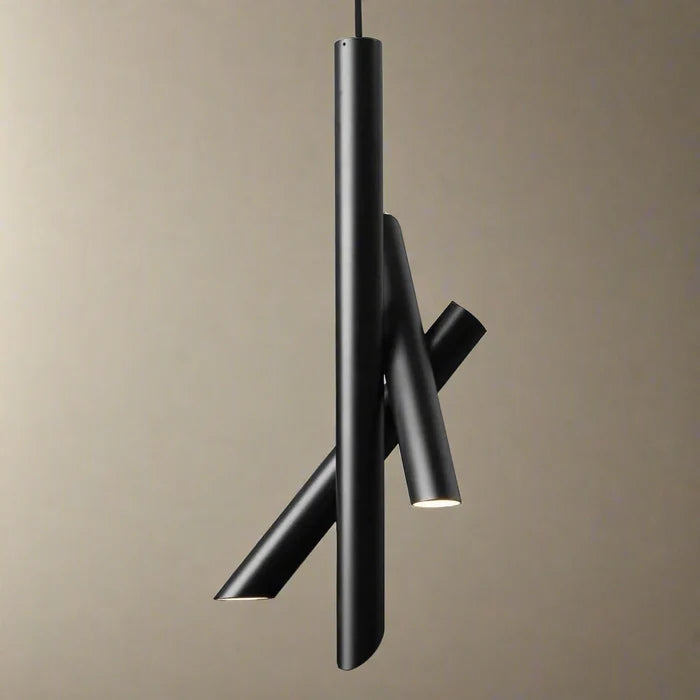 A modern black pendant light fixture with three intersecting cylindrical tubes, shown against a plain beige background.