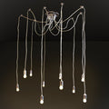 A modern multi-light pendant chandelier with ten hanging Edison-style bulbs suspended from a polished metal ceiling canopy by long cords, shown against a dark studio background.