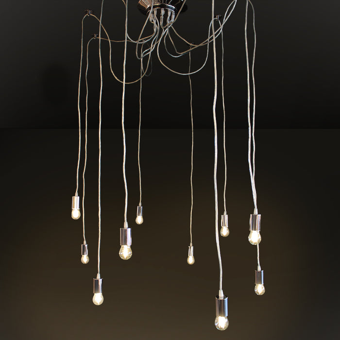 A modern multi-light pendant chandelier with ten hanging Edison-style bulbs suspended from a polished metal ceiling canopy by long cords, shown against a dark studio background.