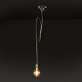 Silver pendant light with amber bulb against dark background