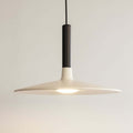 Modern pendant light with a dark fixture on a black background