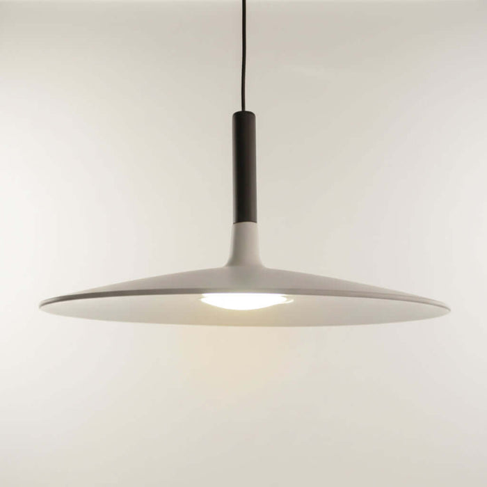 Modern pendant light with a white shade and black fixture on a neutral background